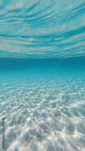Underwater photo of tropical exotic sandy sea bed with turquoise sea