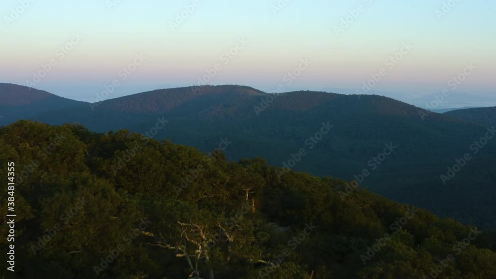 An aerial shot (dolly in) of Cole Mountain seen from the Mount Pleasant summit during a summer sunrise. George Washington National Forest in the Blue Ridge Mountains in Amherst County, Virginia. An aerial shot (dolly in) of Cole Mountain seen from the Mount Pleasant summit during a summer sunrise. George Washington National Forest in the Blue Ridge Mountains in Amherst County, Virginia.