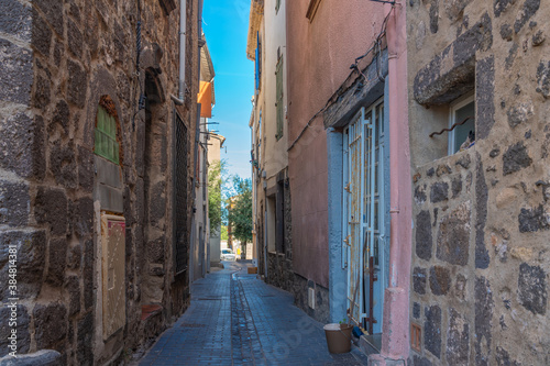Small street at Agde Centre with old Buildings , background blue sky © ggfoto