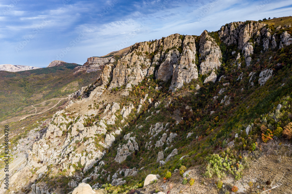 a panoramic view of the beautiful mountains with unusual ledges and rocks against the background of the sky and the valley filmed from a drone a panoramic view of the beautiful mountains with unusual ledges and rocks against the background of the sky and the valley filmed from a drone