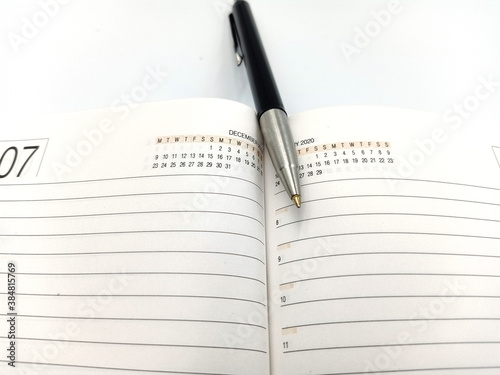 Notice diary with the pen on the isolated white background