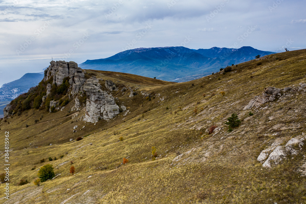 beautiful mountains with unusual ledges and tales against the background of the sky and the valley