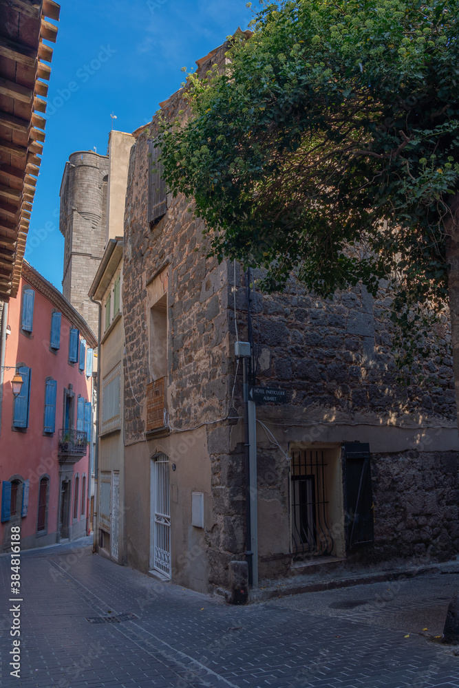 Street view in Agde Centre with old Buildings on a sunny day, vertical