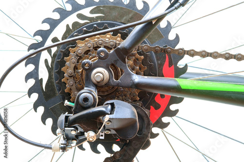 Close-up of bicycle wheel detail, roller chain and rear cassette of a bike