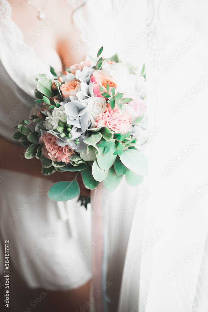 Bride holding big and beautiful wedding bouquet with flowers Bride holding big and beautiful wedding bouquet with flowers