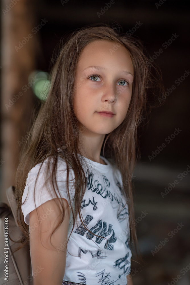 Close-up portrait of a green-eyed girl on a dark background. Close-up portrait of a green-eyed girl on a dark background.