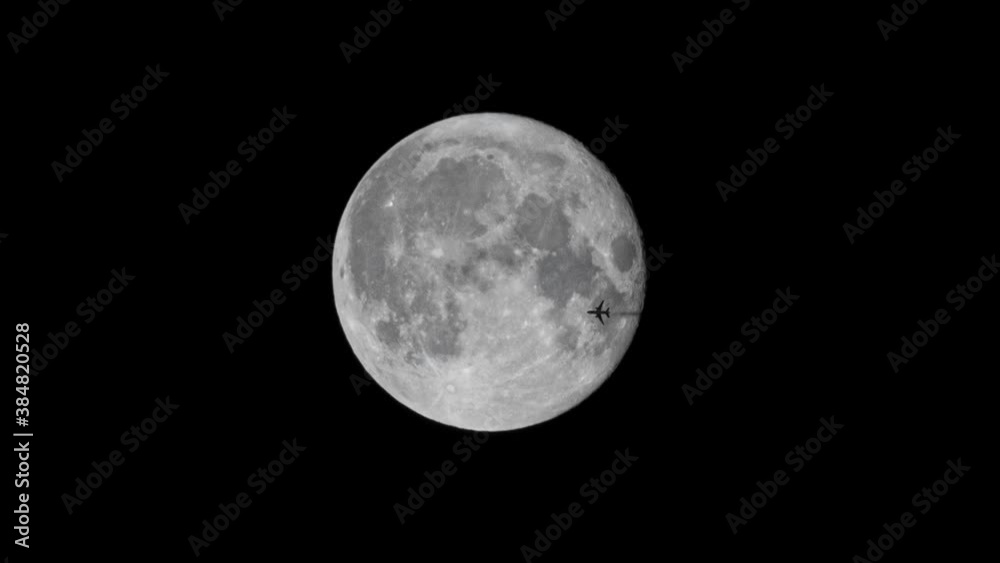 Airplane shape and smoke trail crossing moon light on night black sky. Real moon and airplane animation Airplane shape and smoke trail crossing moon light on night black sky. Real moon and airplane animation