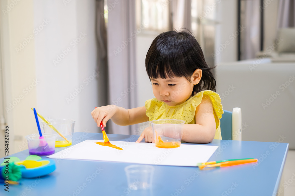 child painting with a paintbrush on the table. toddler draw watercolor. child painting with a paintbrush on the table. toddler draw watercolor.