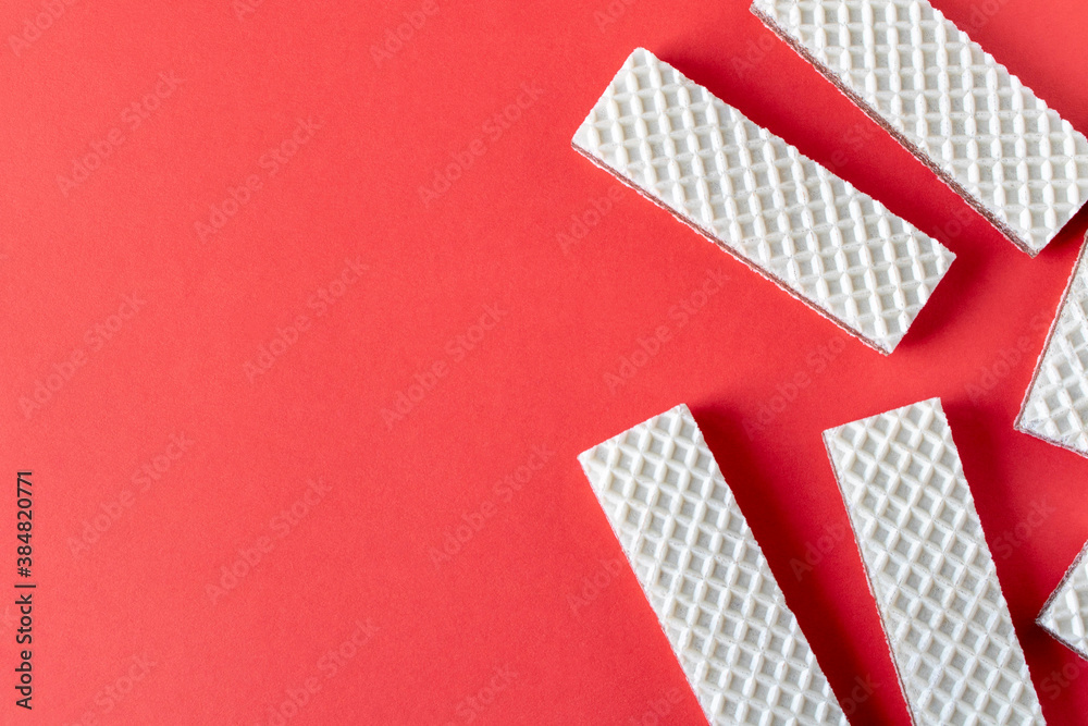 A few waffles with chocolate on an red background. Selective focus. A few waffles with chocolate on an red background. Selective focus.