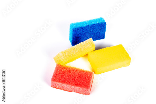 On white background. Dishwashing sponges in different colors. Close-up.
