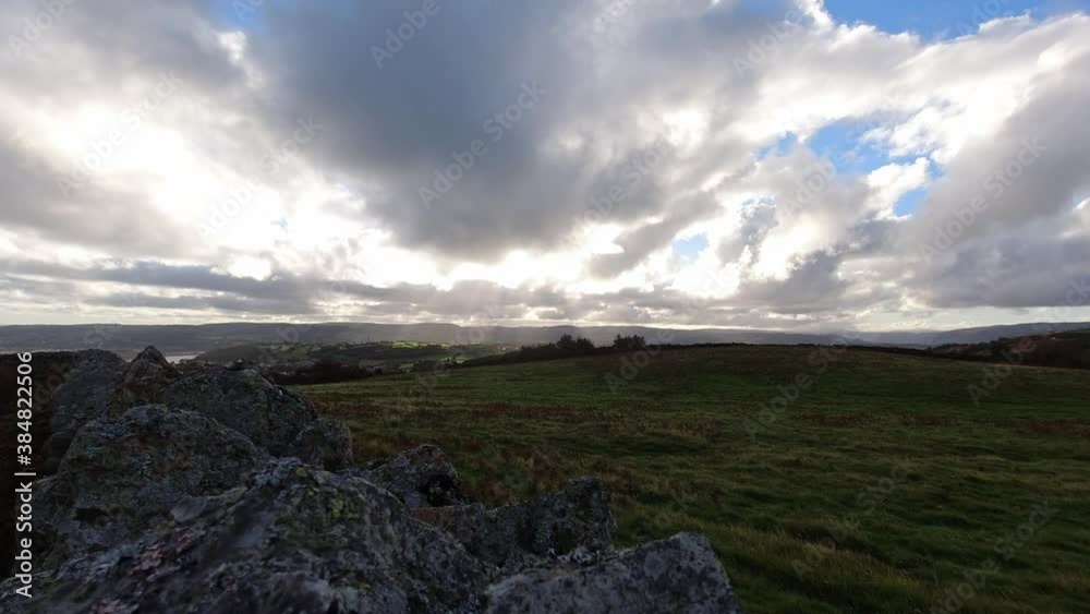 Sunbeams time lapse moving across overcast British agriculture farmland rural countryside scene Sunbeams time lapse moving across overcast British agriculture farmland rural countryside scene