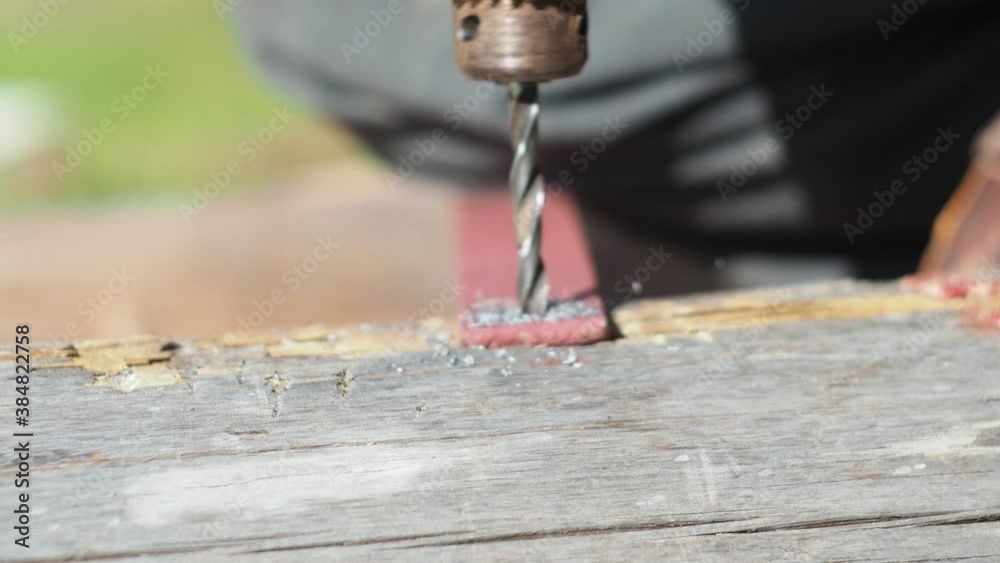 drilling holes in metal with an electric drill. drill bit in the Chuck. metal work. drilling holes in metal with an electric drill. drill bit in the Chuck. metal work.