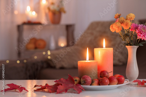 autumn decorations with burning candles at home