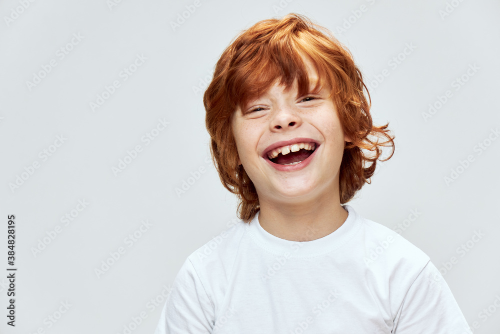 Redhead boy smiles broadly close-up cropped view Redhead boy smiles broadly close-up cropped view