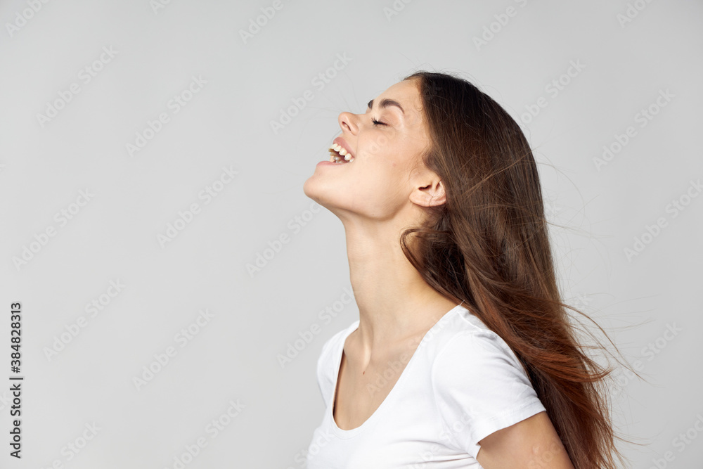 Happy brunette with closed eyes tilted her head back side view Happy brunette with closed eyes tilted her head back side view