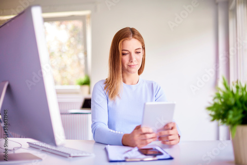 Businesswoman using digital tablet while working in the office Free Download Businesswoman using digital tablet while working in the office - GFXLoad