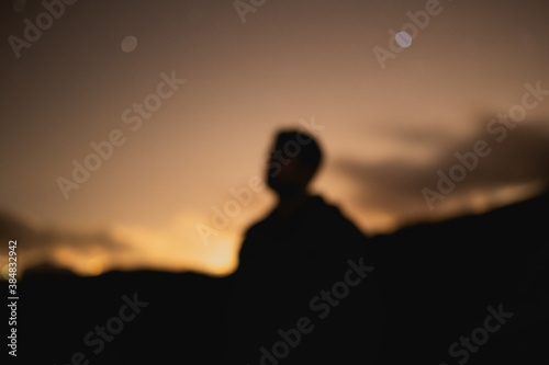 Unfocused shot of a man enjoying the nightsky in the mountains