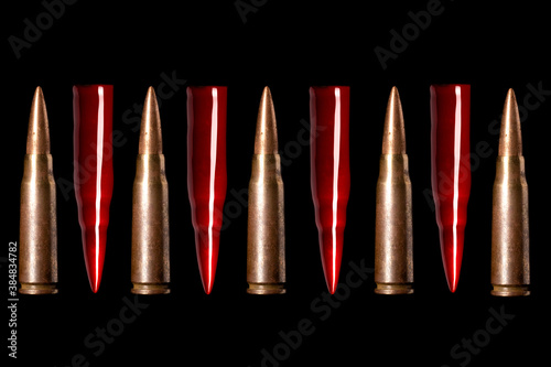 Bullets on black background. Pattern. Symbol of the causes of military conflicts in the world. Bloody bullets. War and violence concept.