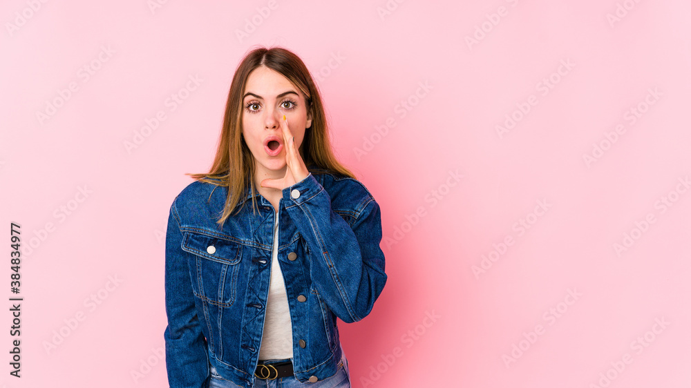 Young caucasian woman isolated on pink background is saying a secret hot braking news and looking aside Young caucasian woman isolated on pink background is saying a secret hot braking news and looking aside