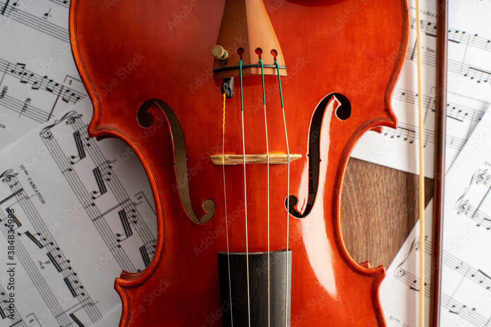 Fototapeta premium Violin body and archer with an undefined musical score