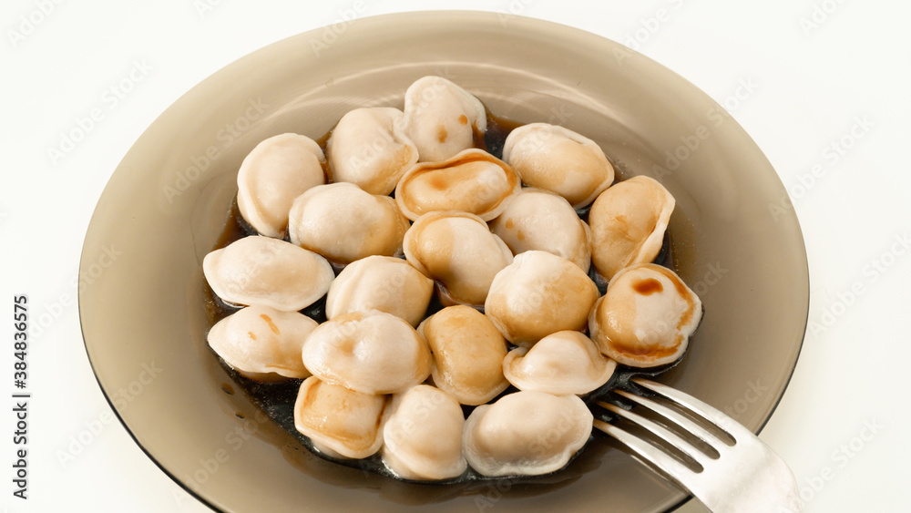 Isolated traditional russian pelmeni, ravioli, dumplings with meat and soy sauce on white background. Design and food styling idea for sale. Home food restaurant, menu or cook book concept Isolated traditional russian pelmeni, ravioli, dumplings with meat and soy sauce on white background. Design and food styling idea for sale. Home food restaurant, menu or cook book concept