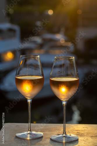 Tasting of local rose wine in summer with sail boats haven of Port Grimaud on background, Provence, France