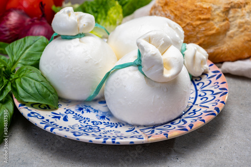 Cheese collection, fresh soft Italian cheese from Puglia, white balls of burrata or burratina cheese made from mozzarella and cream filling