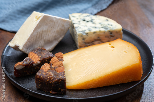 Cheese collection, blue cheese, camembert, brie served as dessert with fig almonds bread photo