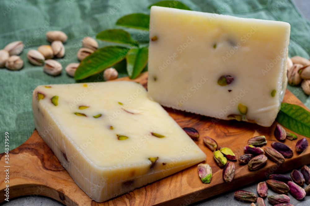 Cheese collection, fresh Italian pecorino cheese made from sheep milk filled with pistachio nuts from Bronte, Sicily
