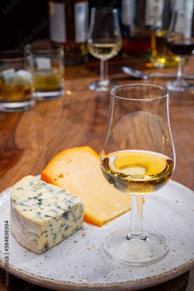 Tasting and pairing of different cheeses with strong alcoholic drinks, whisky, cognac or calvados Tasting and pairing of different cheeses with strong alcoholic drinks, whisky, cognac or calvados