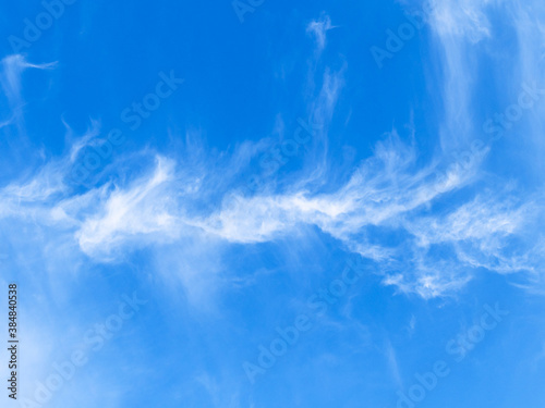 bottom view of white cirrus cloud in blue sky on sunny autumn day