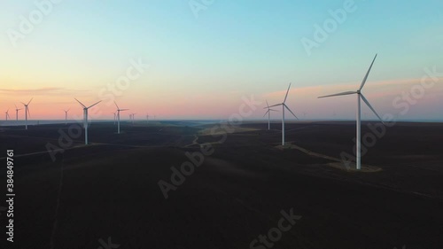 Eolian turbines park at sunet, warm light. Wind power concept
