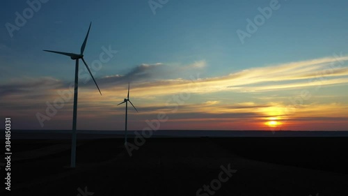 Eolian turbines park at sunet, warm light. Wind power concept
