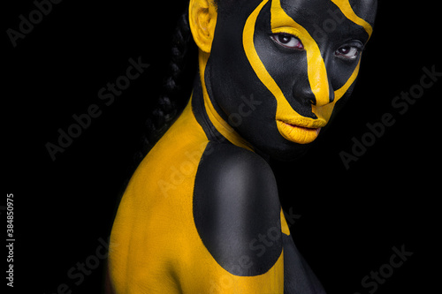 Yellow and black body paint. Woman with face art. Young girl with colorful  bodypaint. An amazing afro american model with makeup. Stock Photo by  ©MikeOrlov 447492266