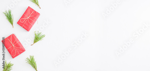 Flat lay frame with pine branches and gift box on a white background