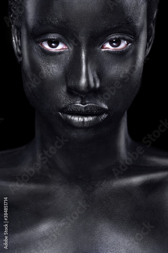 Cheerful young african woman with art fashion makeup. An amazing woman with black bodyart