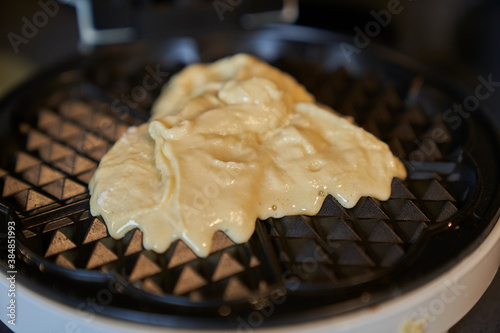 close up of waffle batter in the waffle iron