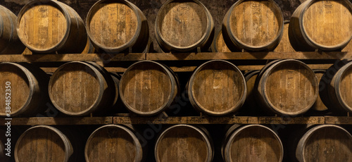 Wooden barrels for wine aging in the cellar. Italian wine. Background