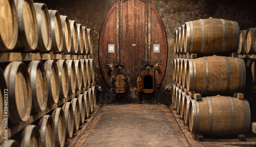 Wooden barrels for wine aging in the cellar. Italian wine. photo