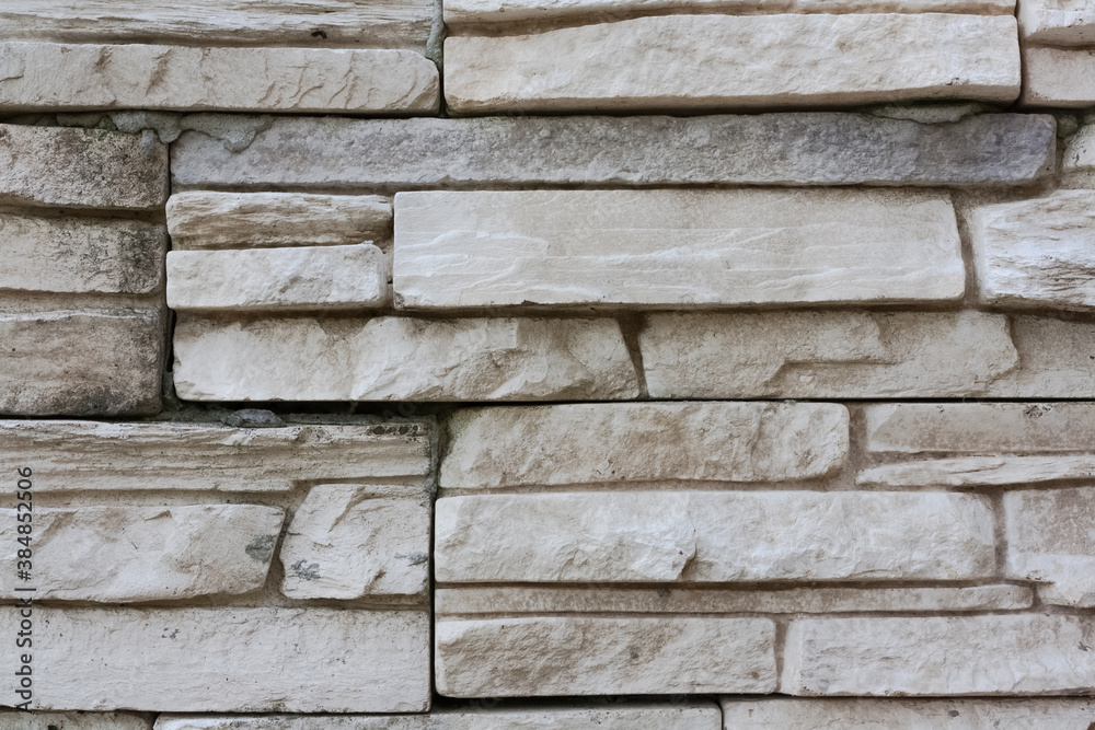Stone surface gray colored with mottled texture. Rocky wall texture background. Clay sandstone bricks Stone surface gray colored with mottled texture. Rocky wall texture background. Clay sandstone bricks