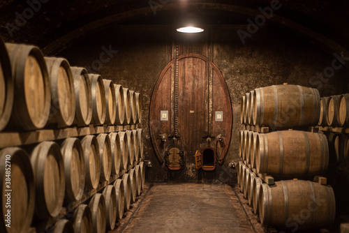 Wooden barrels for wine aging in the cellar. Italian wine.