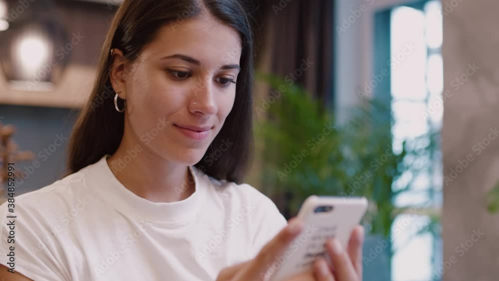 Close-up of nice-looking beautiful woman staying home browsing online internet social media application on smartphone. Young female. Caucasian girl. Technologies.