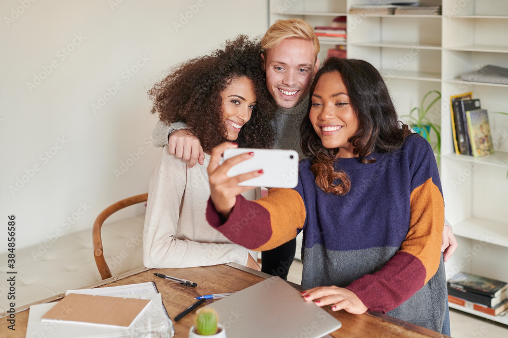 Smiling colleagues taking a selfie Smiling colleagues taking a selfie