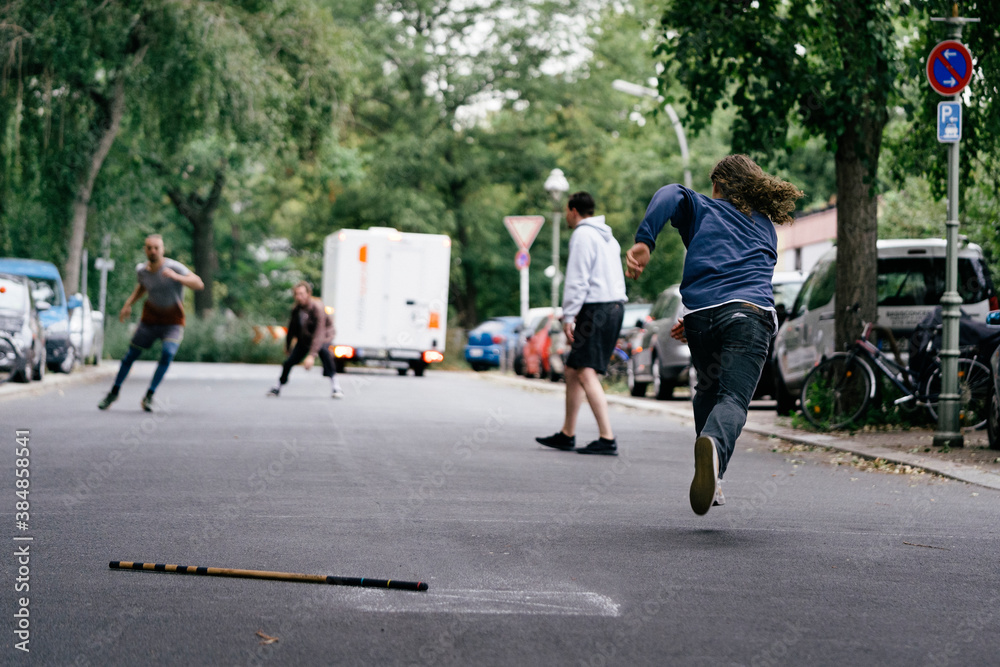 Man Running Down The Street While Playing Stickball Man Running Down The Street While Playing Stickball