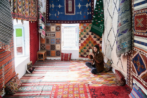 Tourist in carpet shop take photo