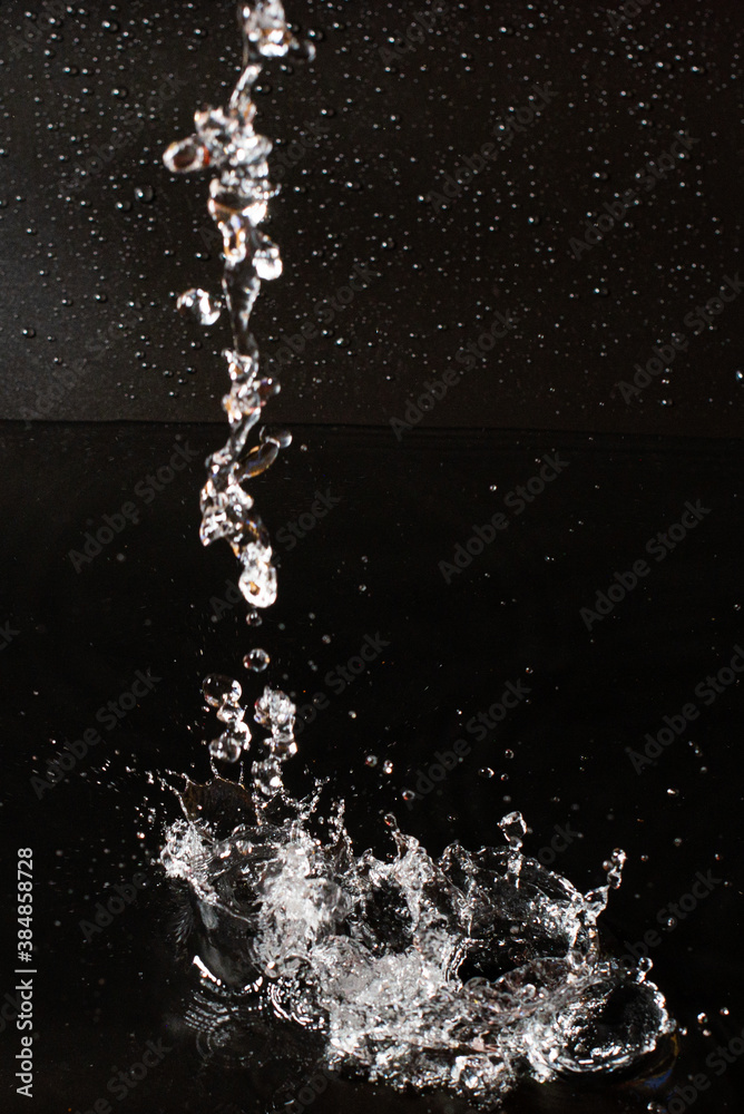 Fototapeta premium Splash of clear water on black isolated background.