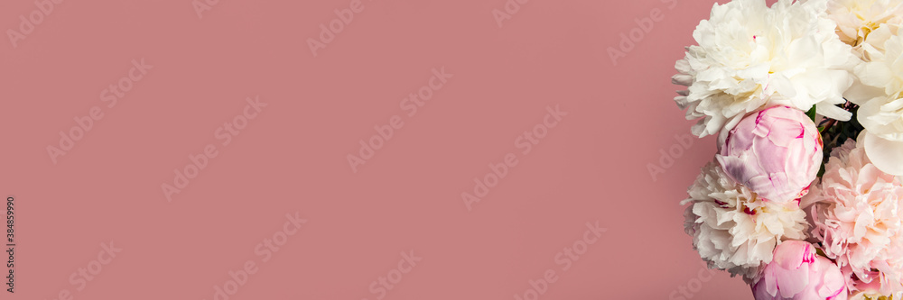 Abundance of Fresh bunch of Peonies Bouquet of different pink colors on pink background. Card Concept, copy space for text, banner size Abundance of Fresh bunch of Peonies Bouquet of different pink colors on pink background. Card Concept, copy space for text, banner size