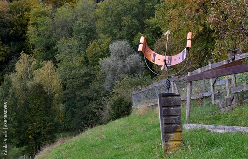A sun clock installed on a sunny hill in Weinfelden in Switzerland. It is made of a thin metal rectangle shaped in a semi circle.  photo