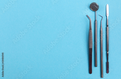 Set of dental instruments on a blue background