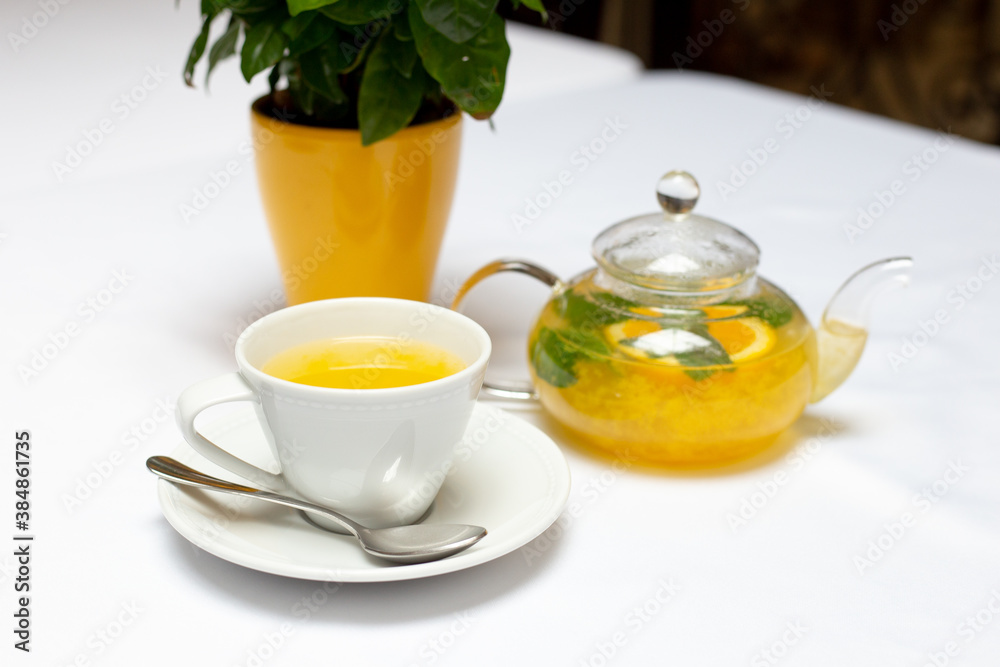 Teapot with orange tea sea ​​buckthorn cup of tea